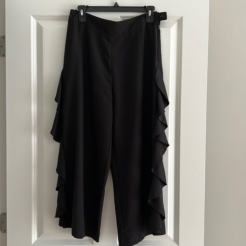 Black, wide leg cropped pants with ruffle sides.